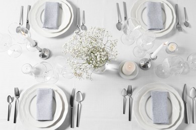 Photo of Beautiful table setting with floral decor, flat lay
