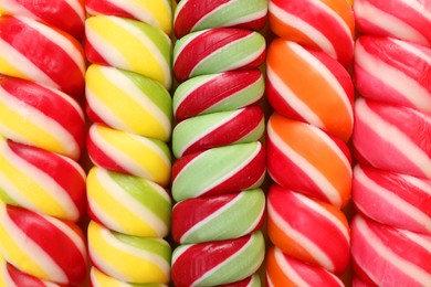 Many delicious colorful lollipops as background, closeup