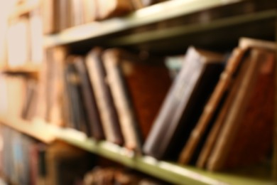 Blurred view of books on shelves in library