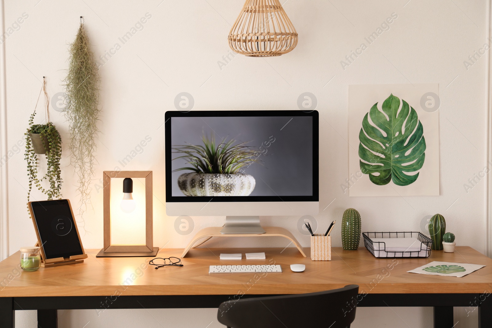 Photo of Modern workplace with computer in room. Interior design