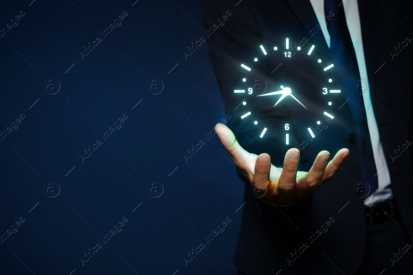 Image of Man holding virtual icon of clock on dark background, closeup. Time management