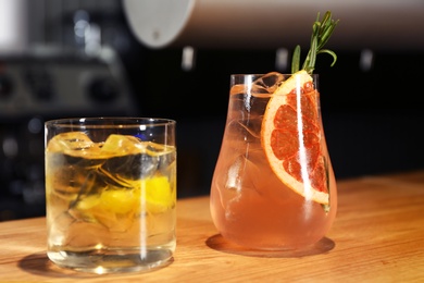 Glasses of delicious cocktail with vodka on wooden counter in bar