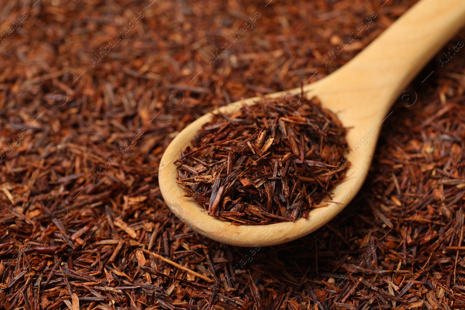 Photo of Rooibos tea and wooden spoon, closeup view