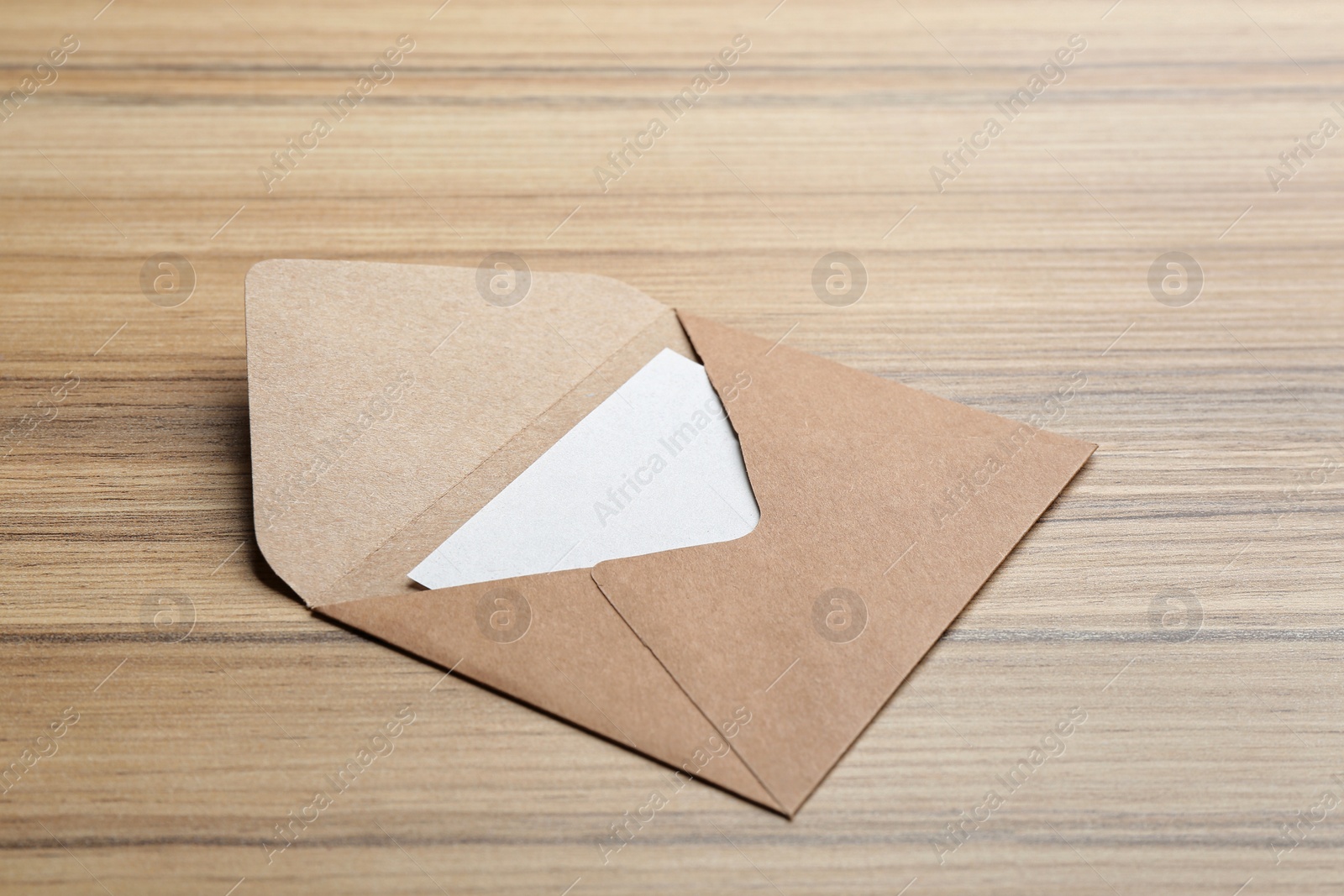 Photo of Brown paper envelope on wooden background. Mail service