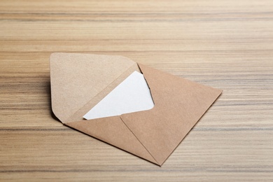 Photo of Brown paper envelope on wooden background. Mail service
