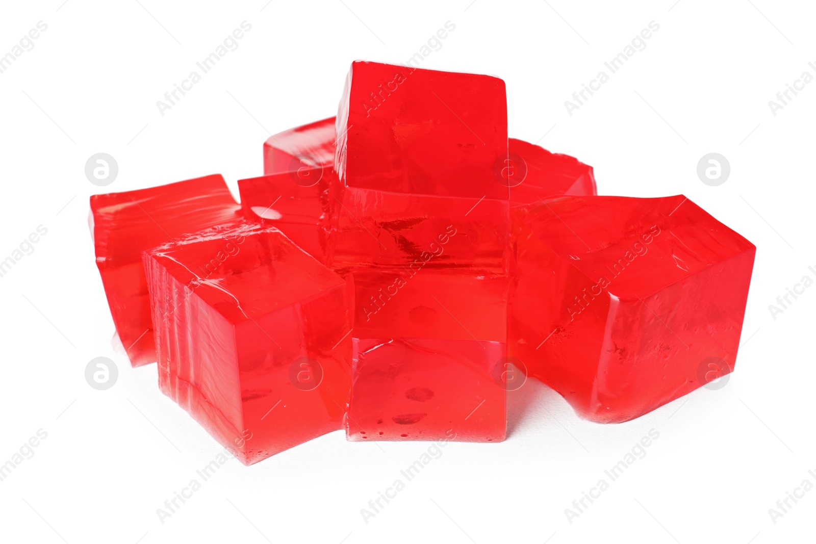 Photo of Heap of red jelly cubes on white background