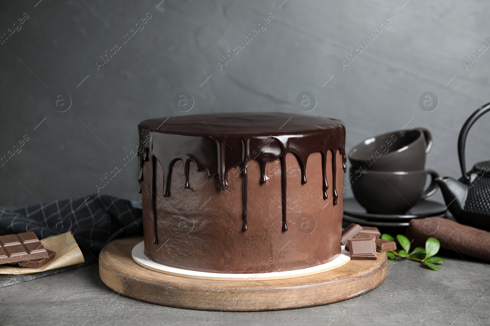 Photo of Freshly made delicious chocolate cake on grey table