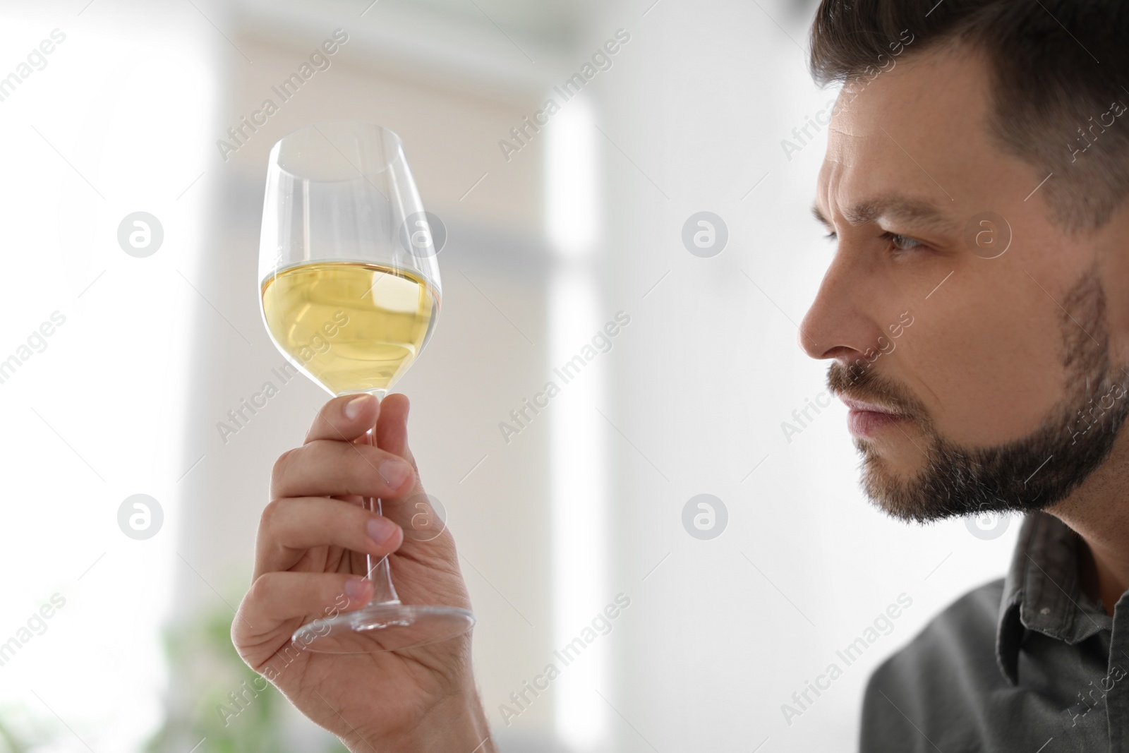 Photo of Man with glass of delicious wine indoors