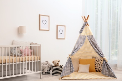 Cozy baby room interior with play tent and crib