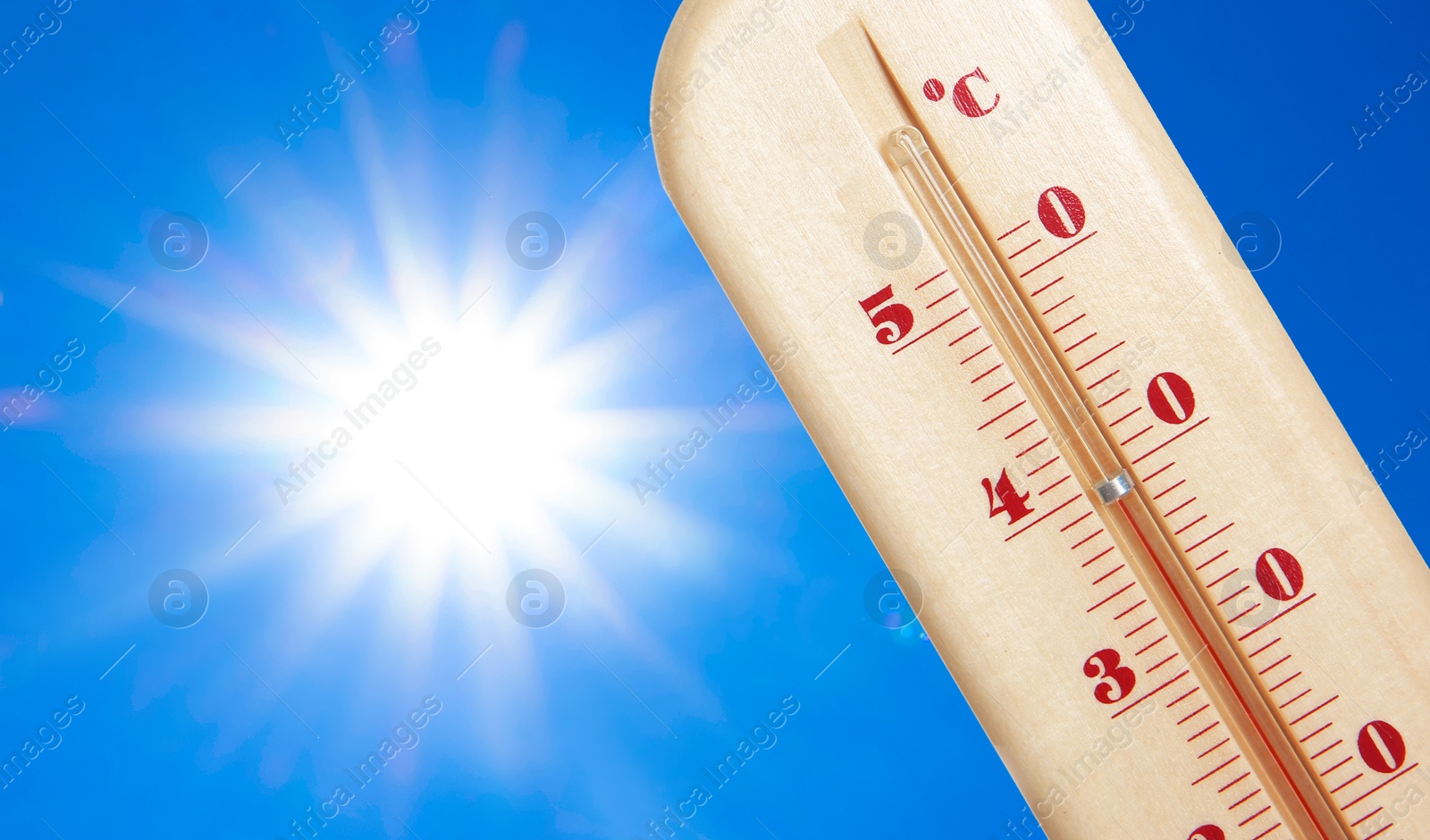 Image of Weather thermometer with high temperature outdoors on hot sunny day. Heat stroke warning