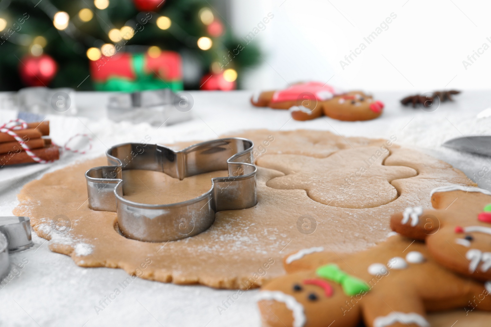 Photo of Making homemade Christmas cookies. Dough for gingerbread man on white table, closeup