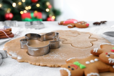 Making homemade Christmas cookies. Dough for gingerbread man on white table, closeup