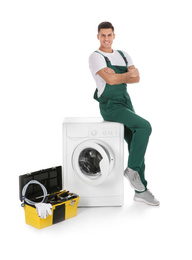Photo of Repairman with toolbox near washing machine on white background