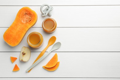 Photo of Tasty baby food in jars, pacifier and ingredients on white wooden table, flat lay. Space for text