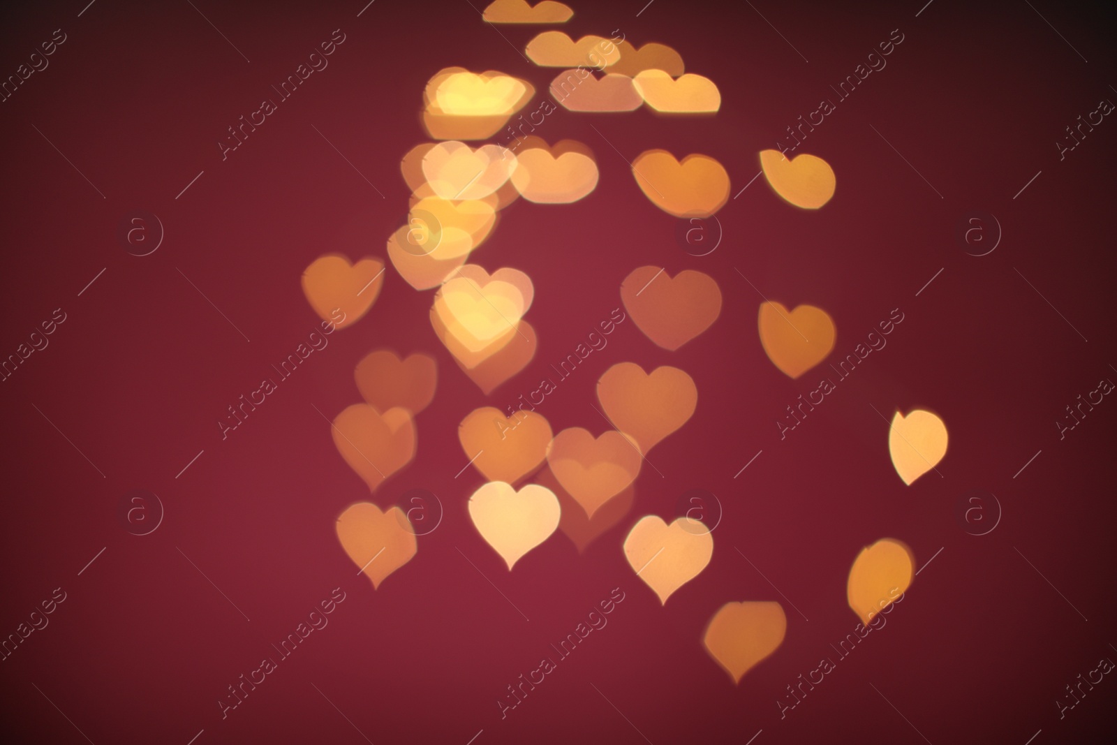 Photo of Blurred view of beautiful lights on burgundy background. Bokeh effect