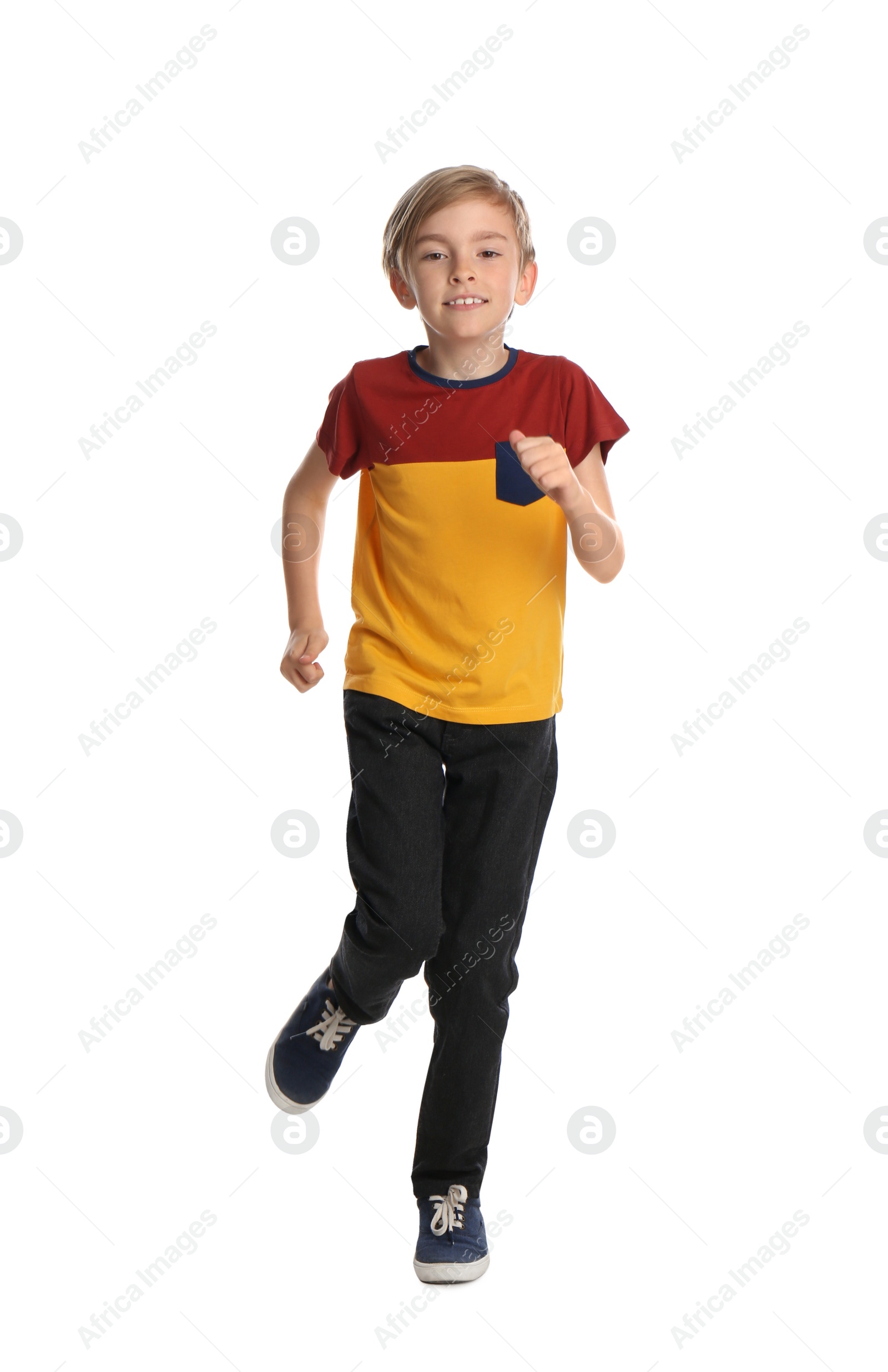 Photo of Cute little boy running on white background