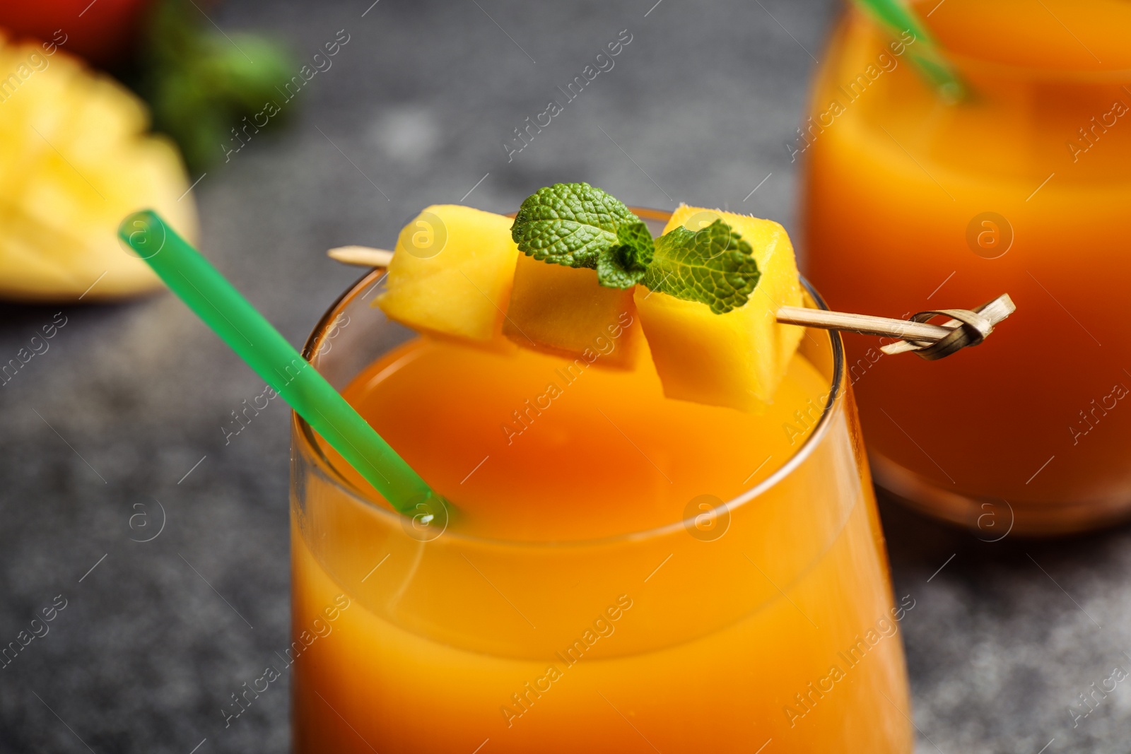 Photo of Fresh delicious mango drink on table, closeup