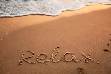 Sandy beach with written word Relax in summer