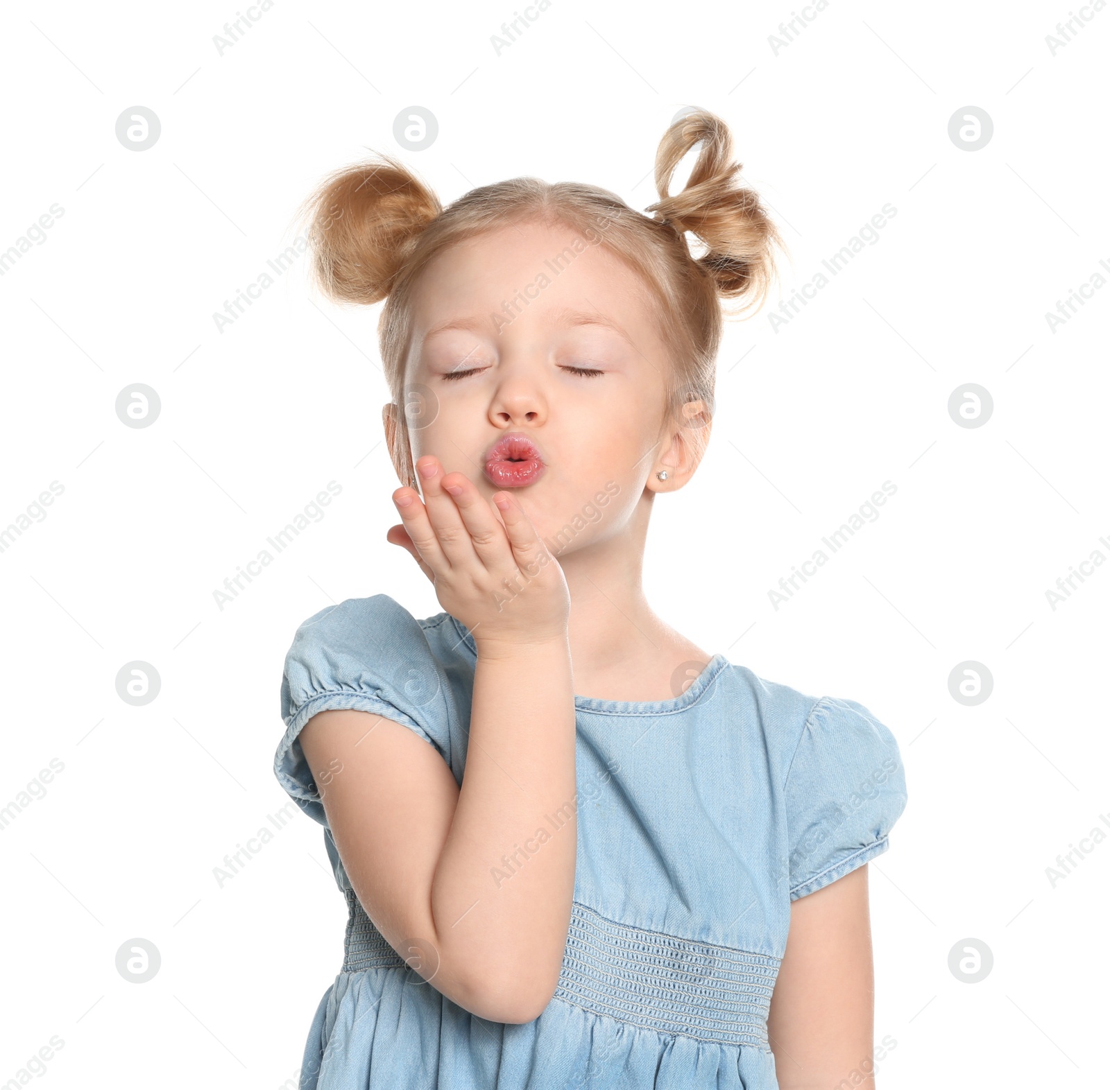 Photo of Cute little girl blowing air kiss on white background