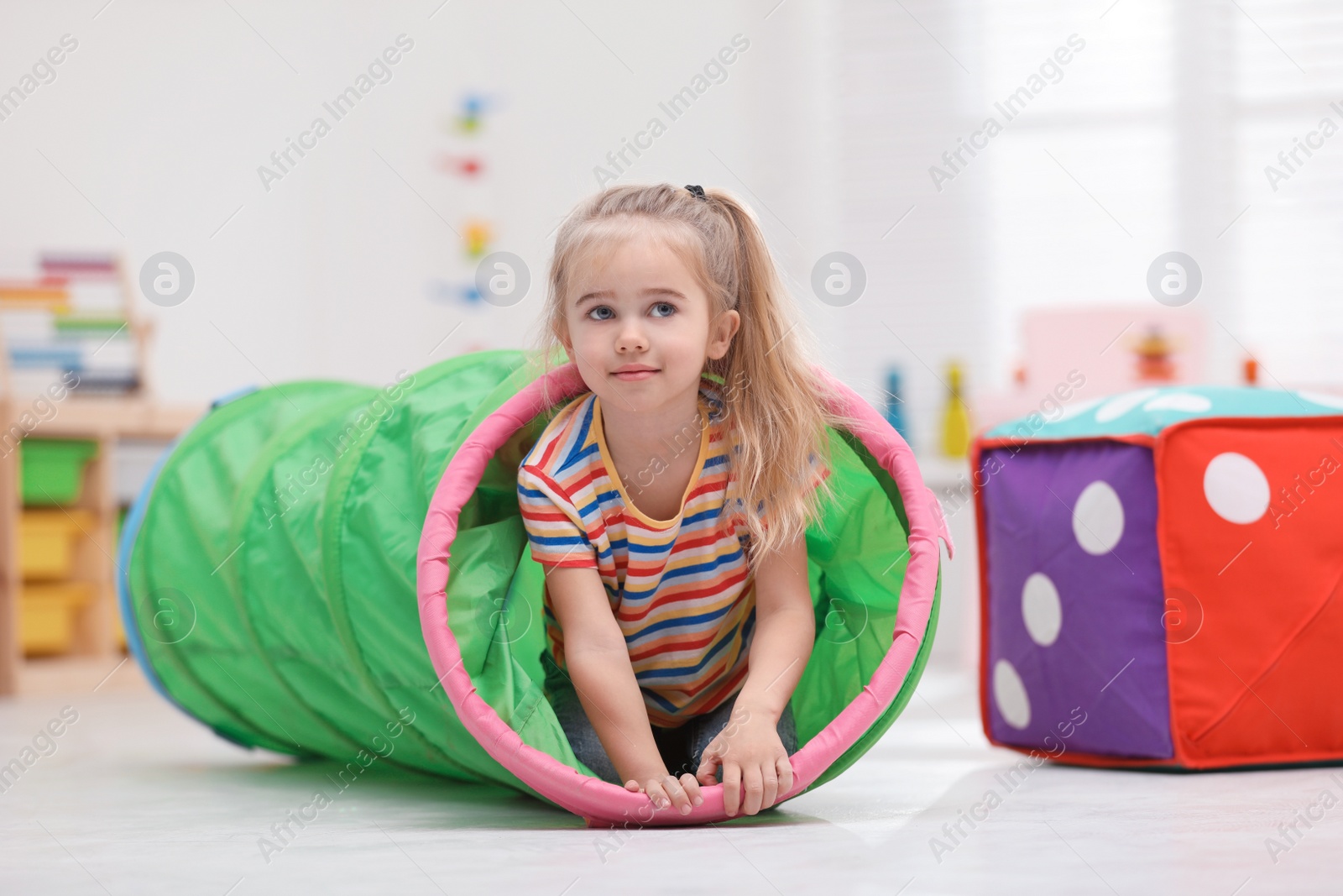 Photo of Cute little child playing on floor at home