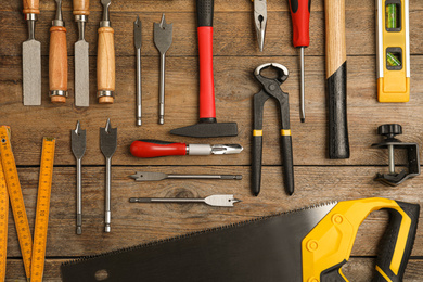 Photo of Flat lay composition with carpenter's tools on wooden background