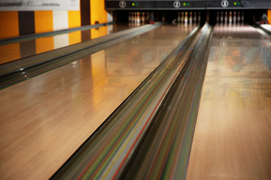 Empty wooden alley lane in modern bowling club