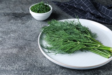 Fresh dill on grey table, space for text