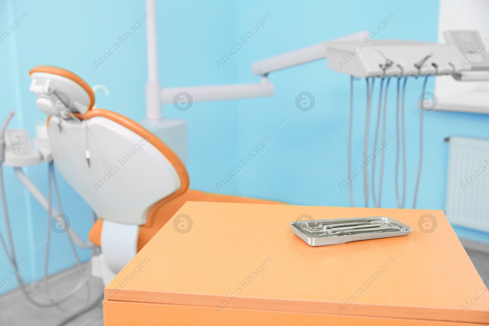Photo of Set of tools on table in dentist's office. Space for text