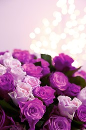 Bouquet of violet roses against blurred background, closeup. Funeral attributes