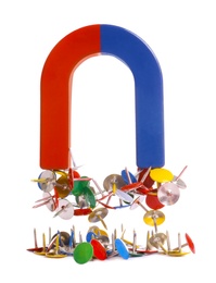Photo of Horseshoe magnet attracting colorful drawing pins on white background