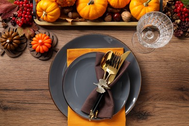 Thanksgiving table setting. Plates, cutlery, glass and autumn decor, flat lay