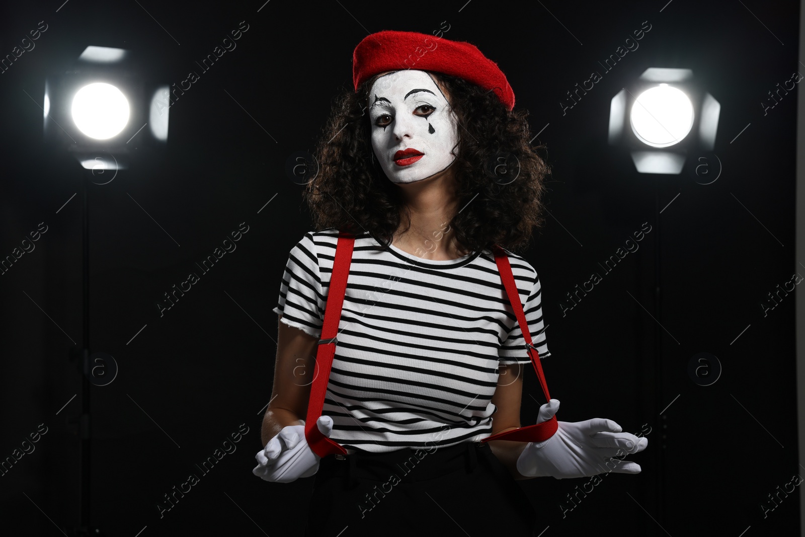 Photo of Young woman in mime costume performing on stage