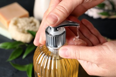 Photo of Woman using liquid soap dispenser, closeup view