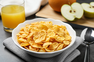 Tasty corn flakes on grey table, closeup