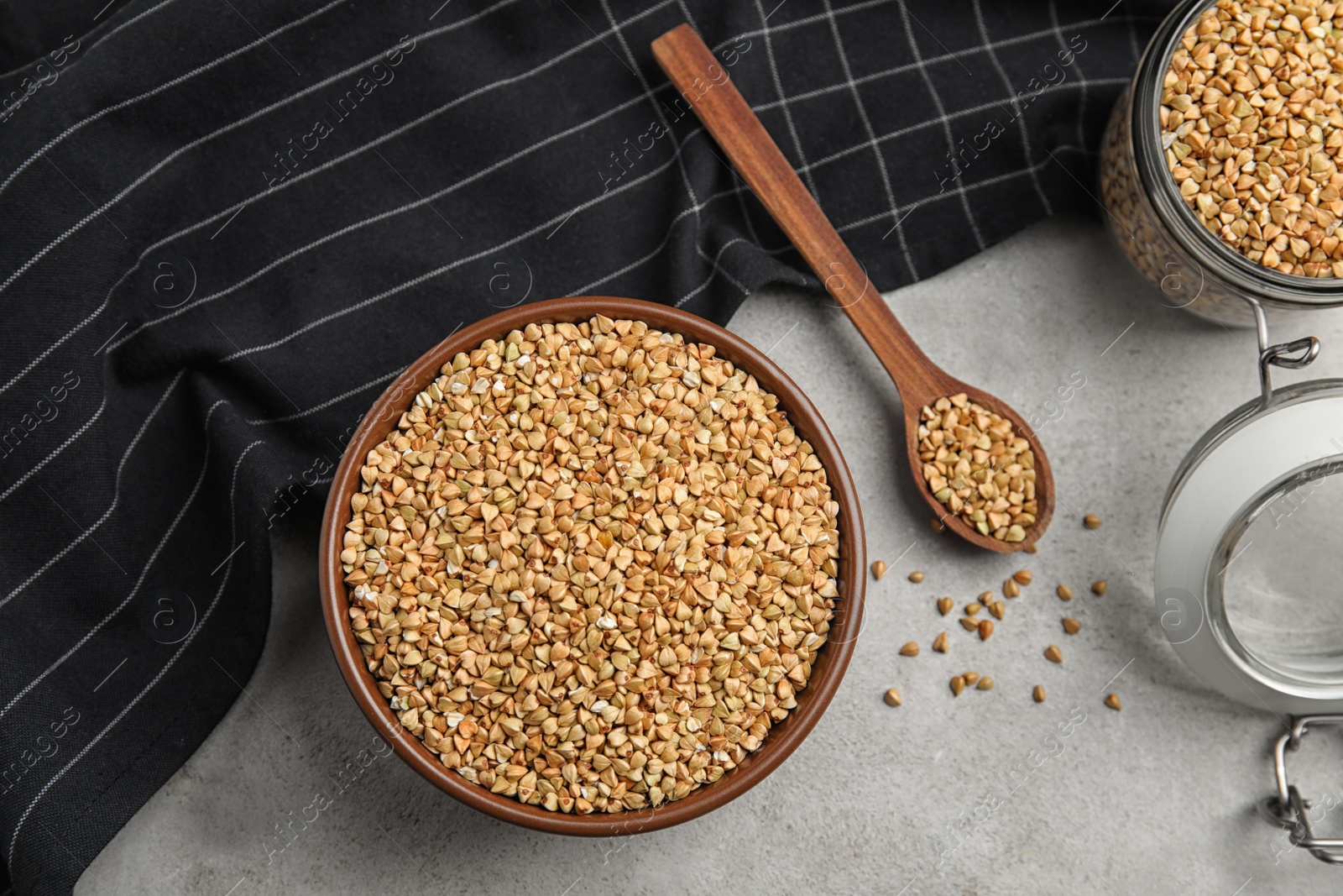 Photo of Uncooked green buckwheat grains on table, flat lay