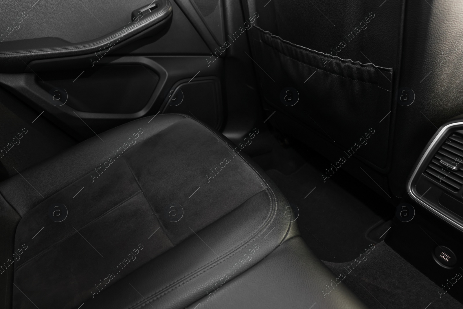 Photo of Leather seat inside of modern black car, closeup