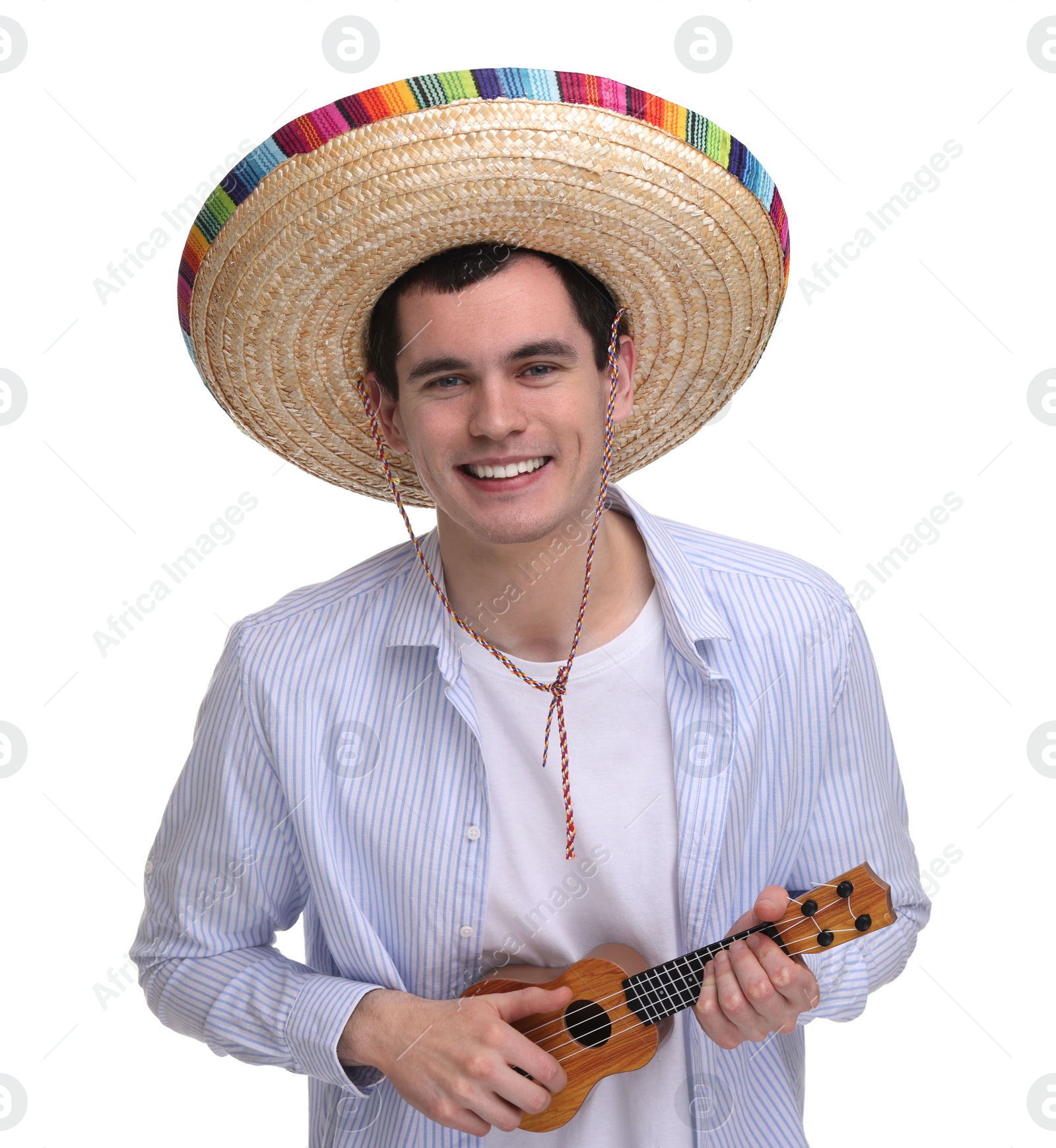 Photo of Young man in Mexican sombrero hat playing ukulele on white background