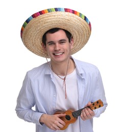 Young man in Mexican sombrero hat playing ukulele on white background