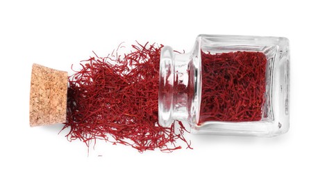 Photo of Aromatic saffron and glass jar isolated on white, top view