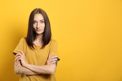 Photo of Portrait of pretty young woman with gorgeous chestnut hair on yellow background, space for text