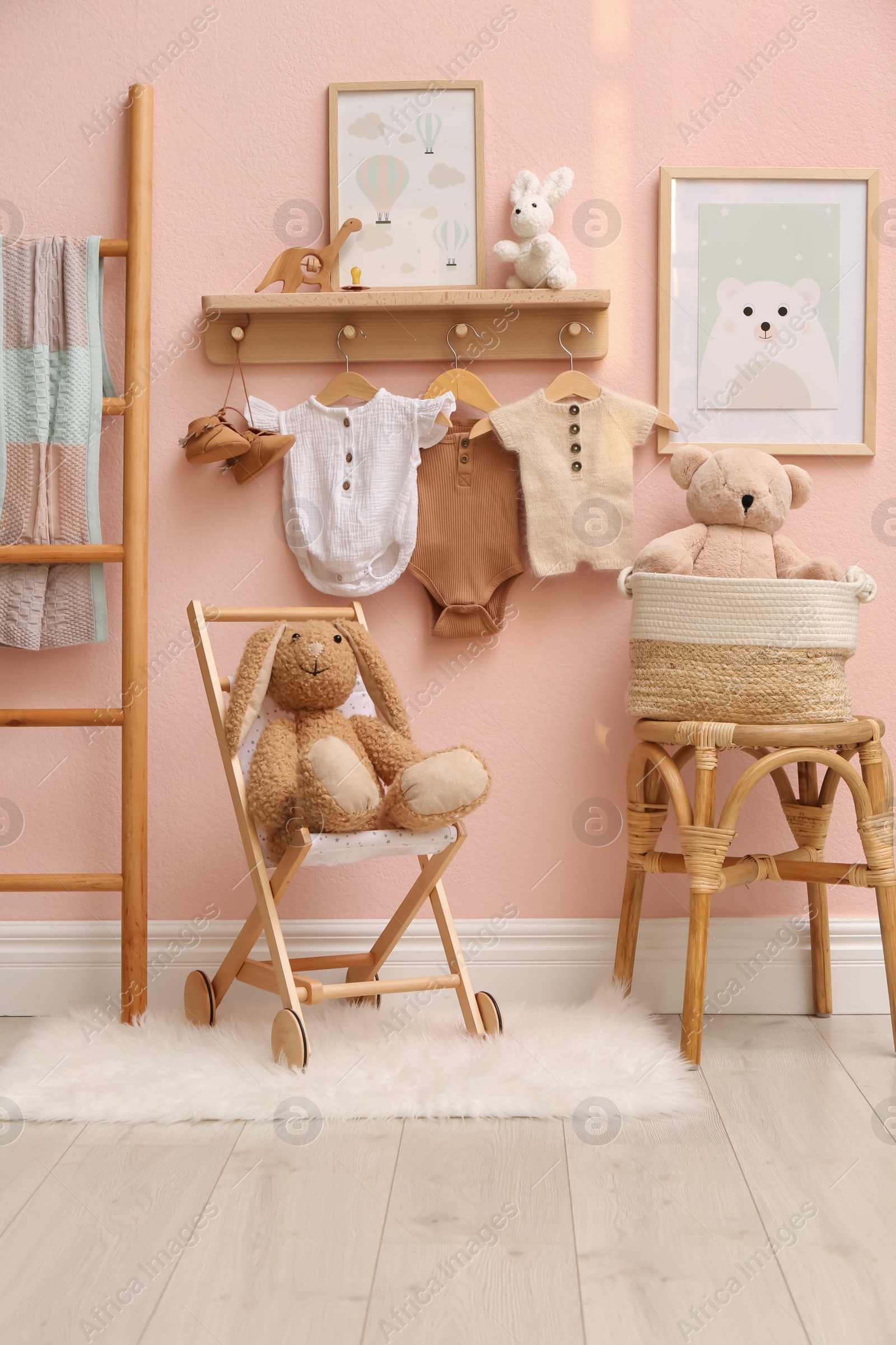 Photo of Cute room interior with baby clothes and toys