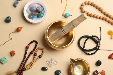 Photo of Flat lay composition with golden singing bowl on beige background. Sound healing