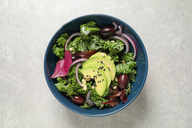 Photo of Tasty fresh kale salad on light grey table, top view