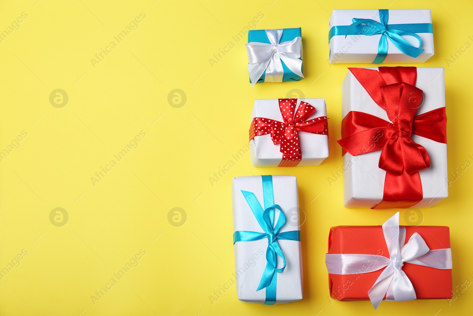 Photo of Flat lay composition with gift boxes on color background