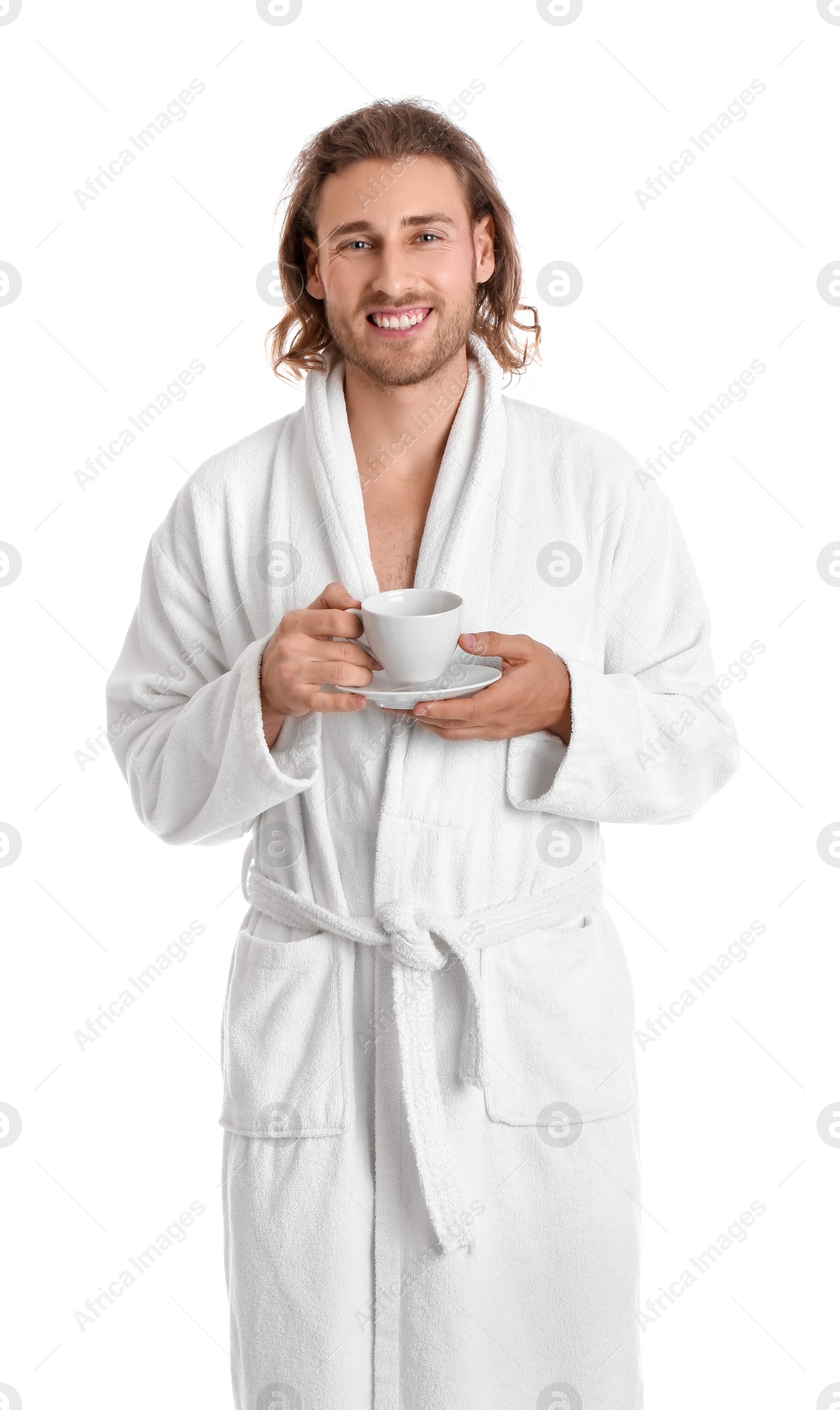 Photo of Young man in bathrobe with cup of drink on white background