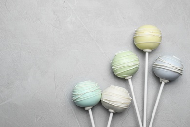 Sweet cake pops on light grey background, flat lay. Space for text