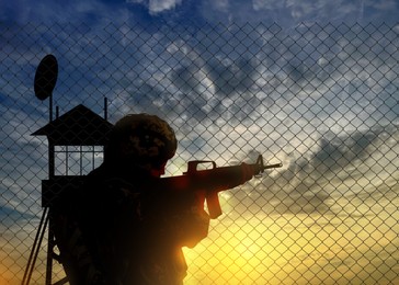 Silhouette of border guard at post outdoors in early morning