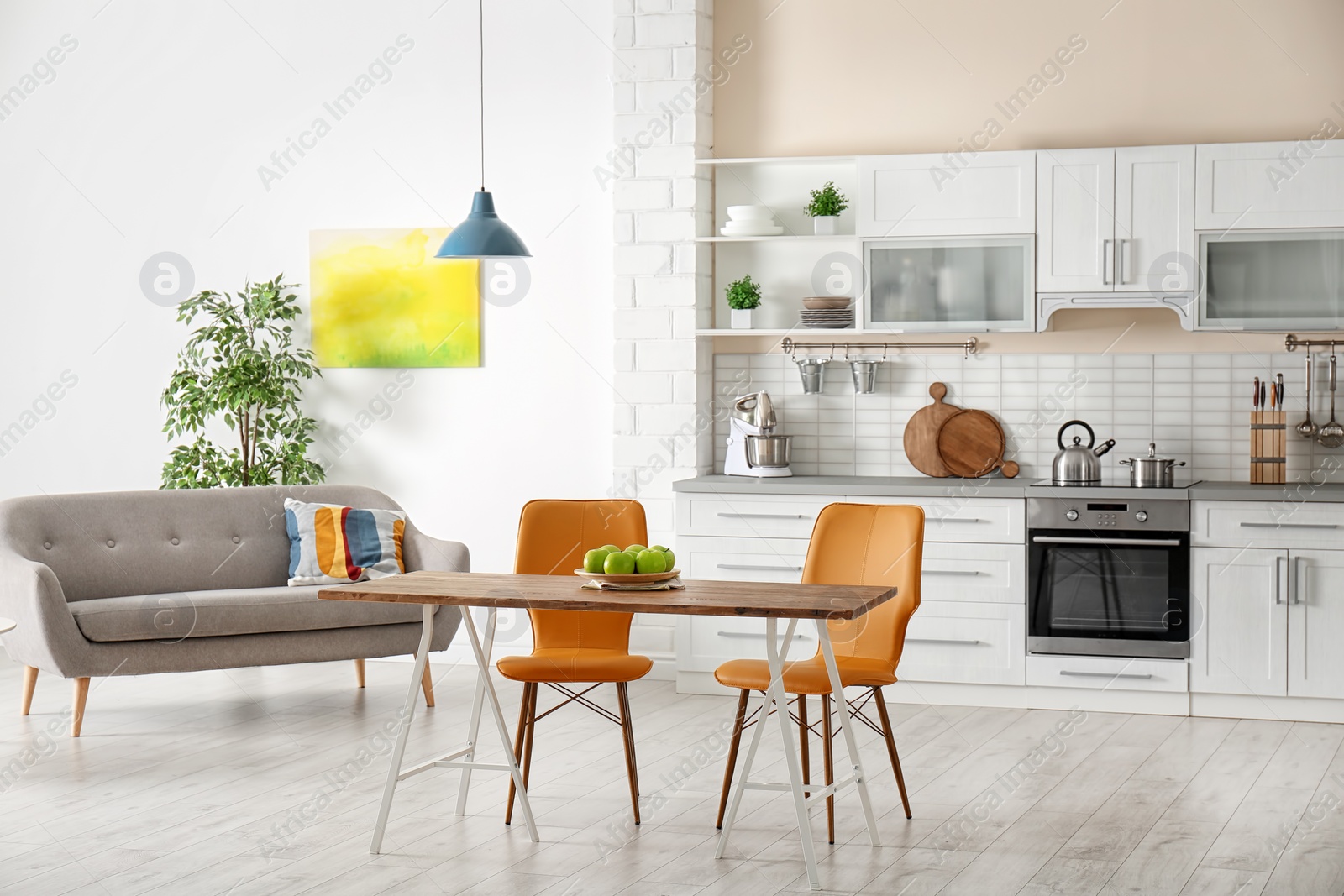 Photo of Stylish apartment interior with kitchen furniture and sofa
