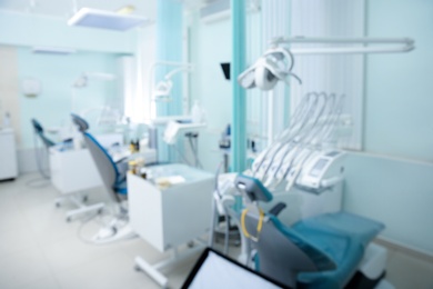 Blurred view of dentist office with chairs and professional equipment