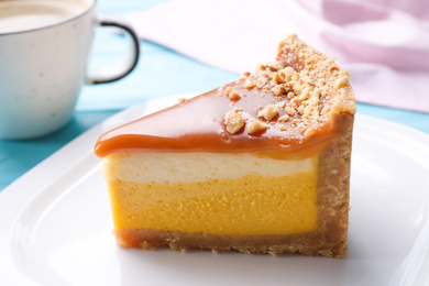 Piece of delicious cake with caramel on table, closeup